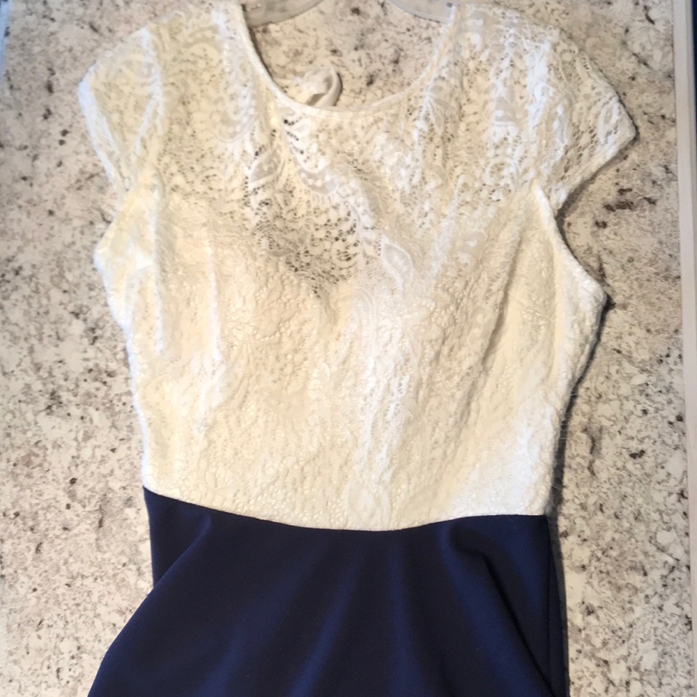 A young girls dress that is white and blue.